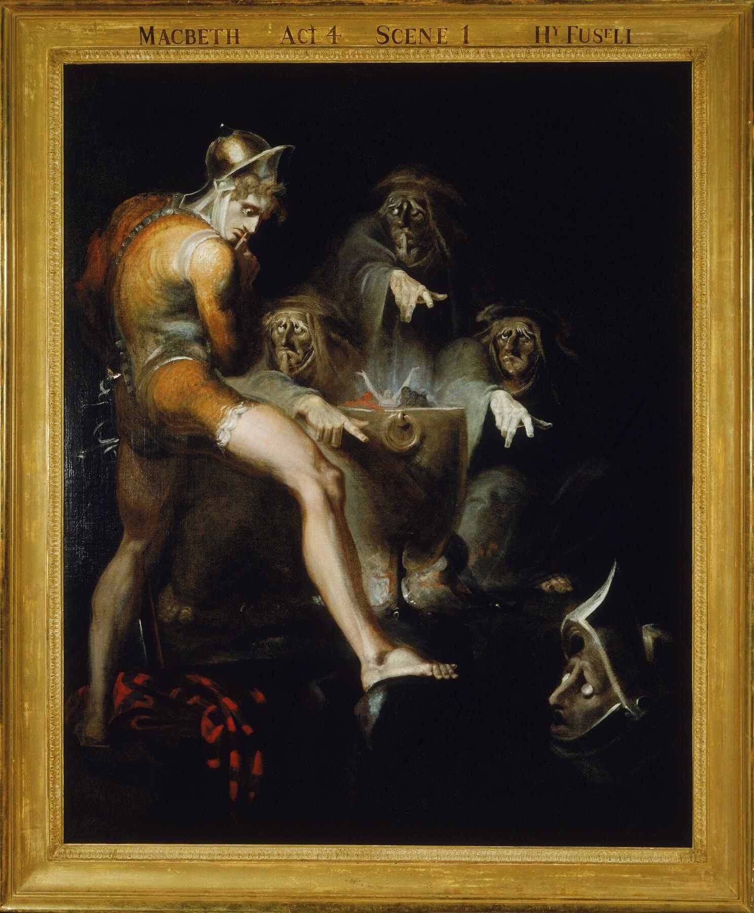 Macbeth recoils from an armed head raised by the witches
